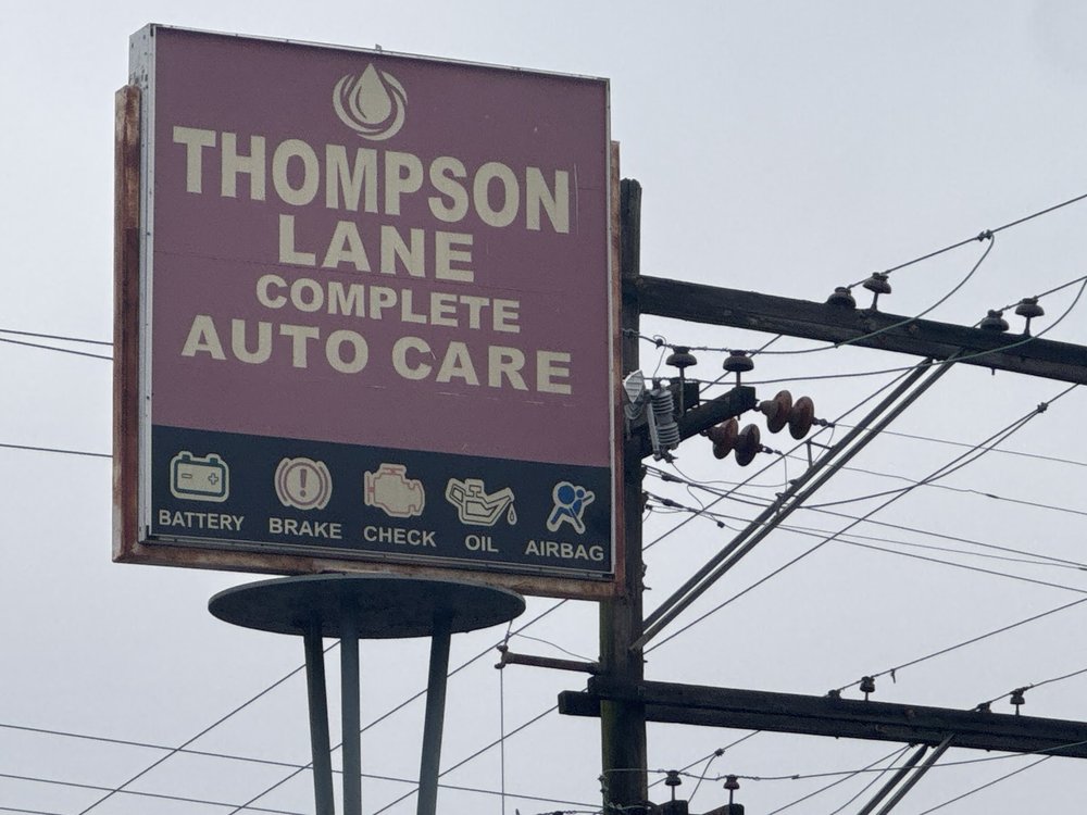 Thompson Lane Complete Auto Care road sign in Nashville, TN