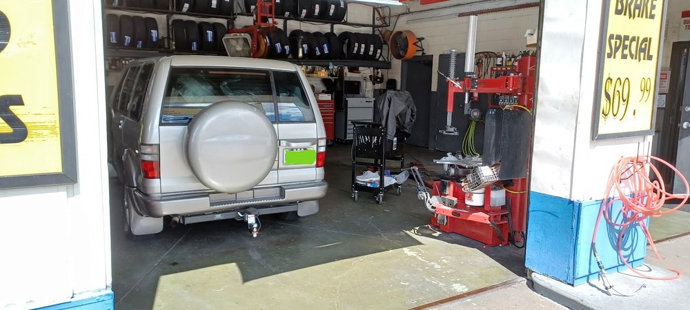 SUV in the tire service bay at Thompson Lane Auto, Nashville, TN